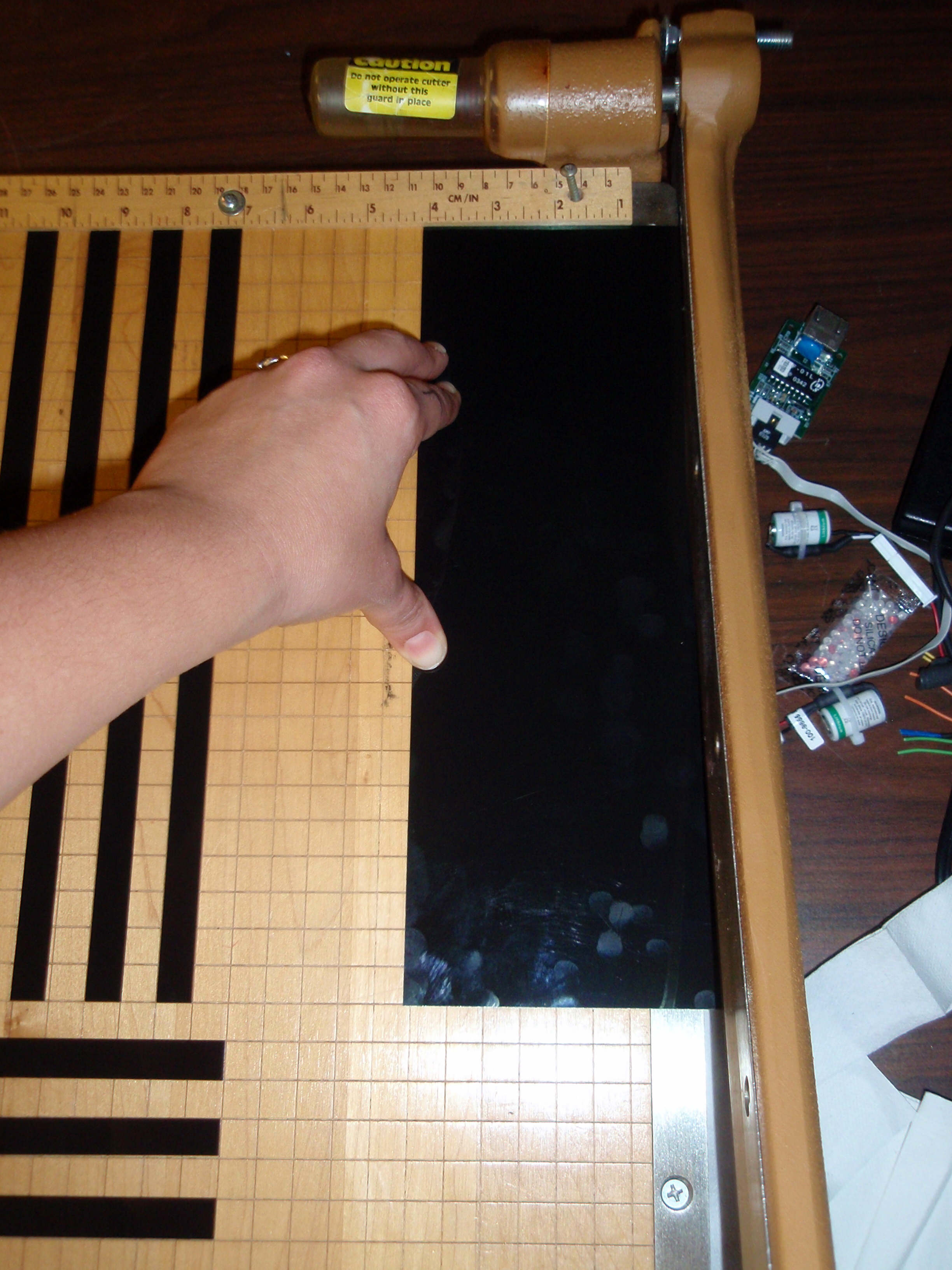 Cutting the liquid crystal sheets into 1/2" strips.